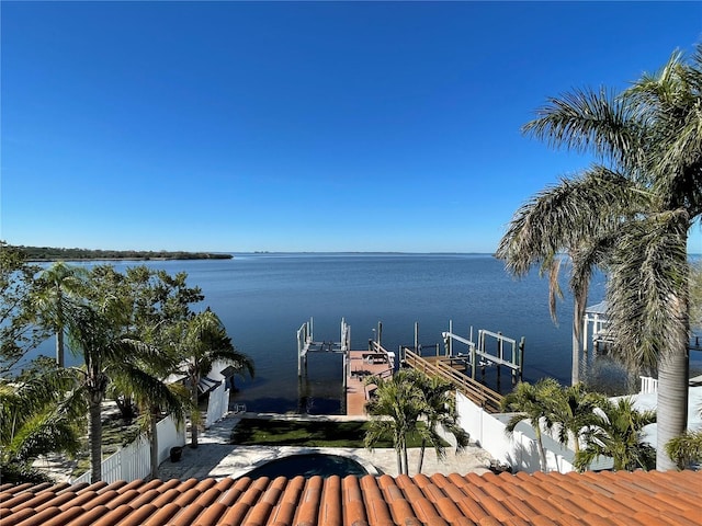 property view of water featuring boat lift and a dock