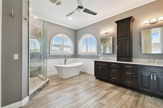 full bathroom with a sink, wood finished floors, a stall shower, and a ceiling fan