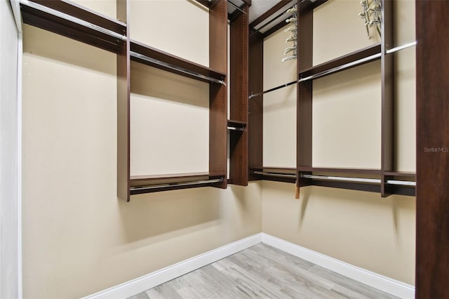 spacious closet with wood finished floors