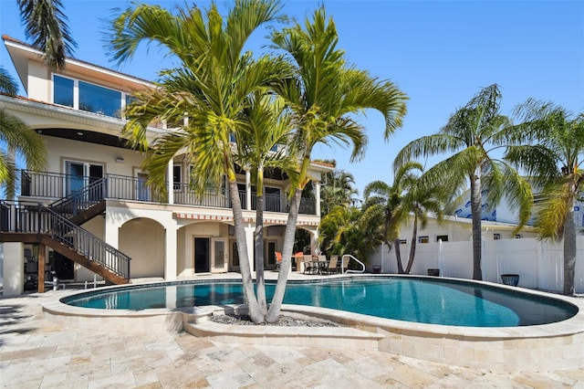 view of pool with a fenced in pool, stairs, a patio, and fence