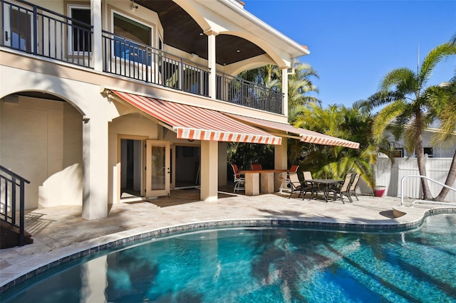 view of swimming pool with a fenced in pool, fence, and a patio area