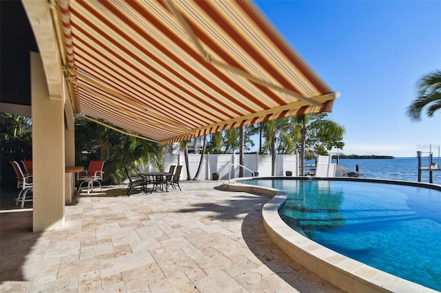 view of swimming pool with a patio, fence, a fenced in pool, outdoor dining area, and a water view