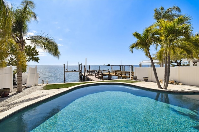 view of pool featuring a fenced in pool, a water view, fence, boat lift, and a boat dock