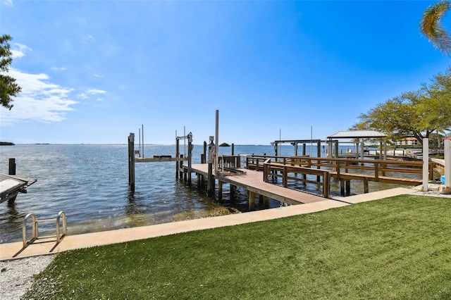 dock area with a yard, a water view, and boat lift