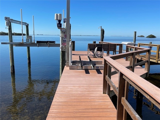 dock area featuring a water view and boat lift