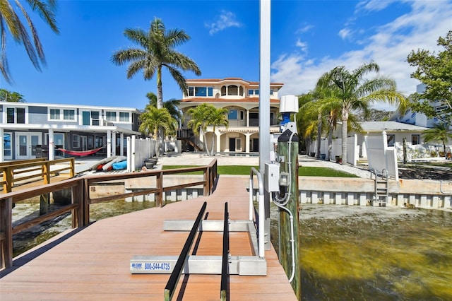 dock area with a water view and boat lift