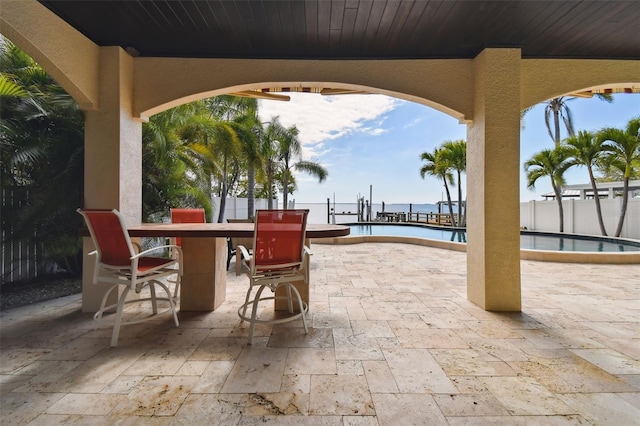 view of patio / terrace featuring outdoor dry bar, a community pool, and fence