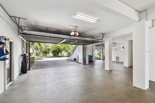 garage featuring a garage door opener and visible vents