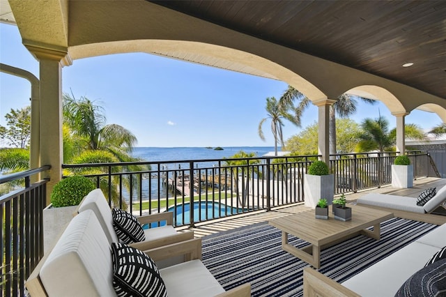 balcony with outdoor lounge area and a water view