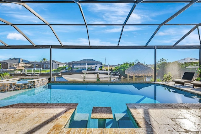 view of pool with glass enclosure, a patio, a dock, a pool with connected hot tub, and a residential view