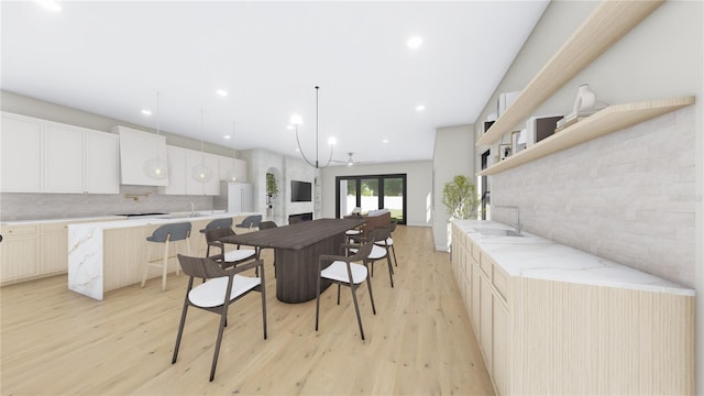 kitchen featuring open shelves, backsplash, freestanding refrigerator, and light wood finished floors