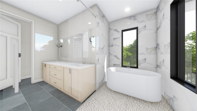 full bathroom with a wealth of natural light, a freestanding tub, recessed lighting, and vanity