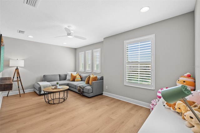 living room featuring recessed lighting, visible vents, baseboards, and light wood finished floors