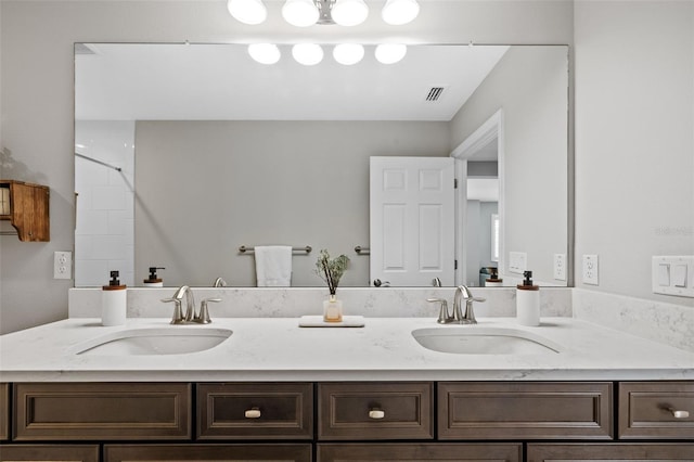 full bathroom featuring a sink, visible vents, and double vanity