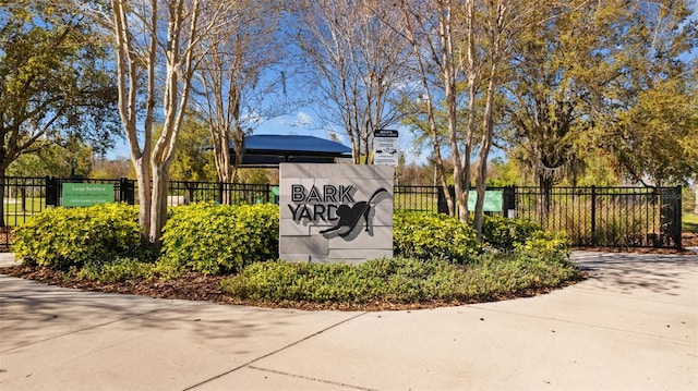 community sign featuring fence