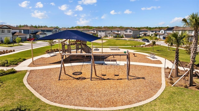 community play area with a residential view and a yard