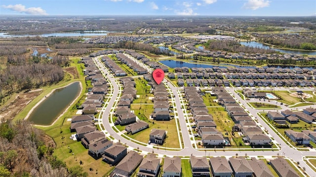 drone / aerial view with a residential view and a water view