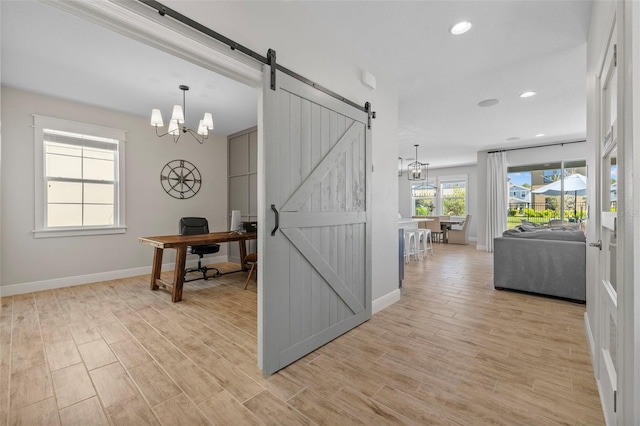 interior space with recessed lighting, a barn door, light wood finished floors, baseboards, and a chandelier