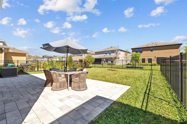 view of patio featuring outdoor dining space, fence, and a residential view