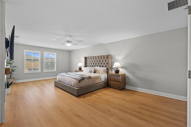 bedroom with a ceiling fan, baseboards, visible vents, and light wood-type flooring