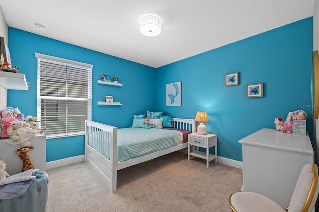 carpeted bedroom featuring baseboards