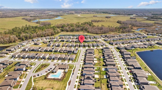 bird's eye view with a water view and a residential view