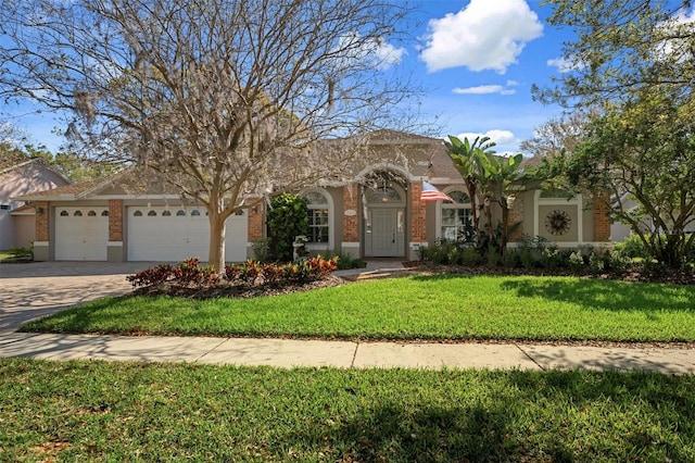 view of front of property with brick siding, a front yard, stucco siding, driveway, and an attached garage