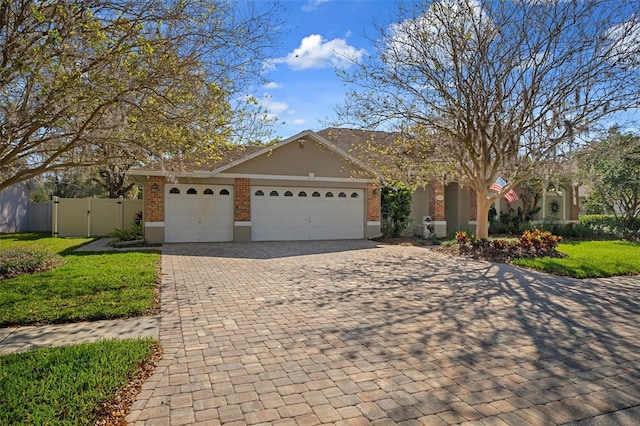 ranch-style home featuring a gate, fence, a garage, decorative driveway, and brick siding