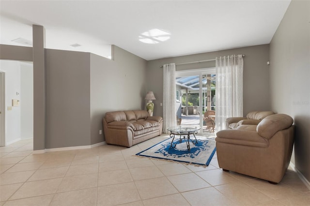 living room featuring light tile patterned floors and baseboards