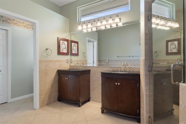 full bathroom with a sink, two vanities, tile walls, and tile patterned floors