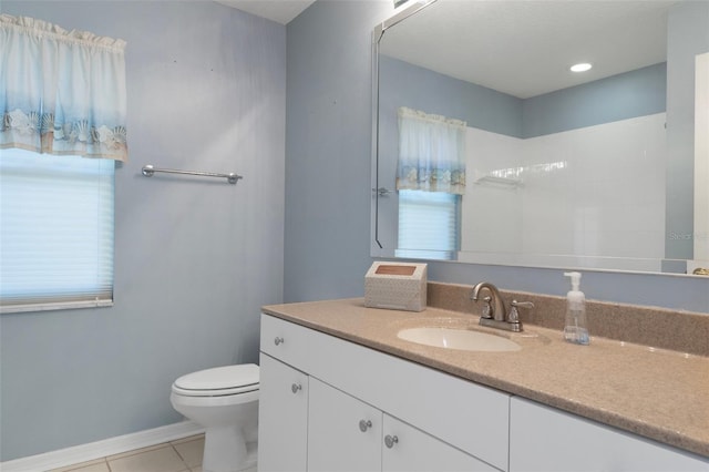 bathroom with tile patterned flooring, toilet, vanity, and baseboards