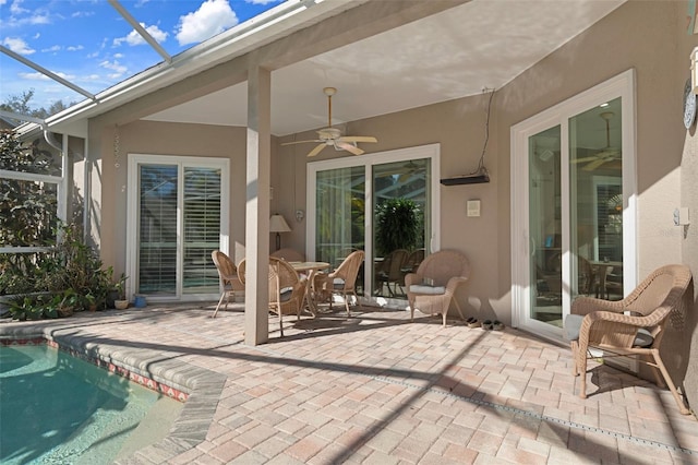 view of patio with a lanai and ceiling fan