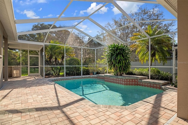 pool with a lanai and a patio