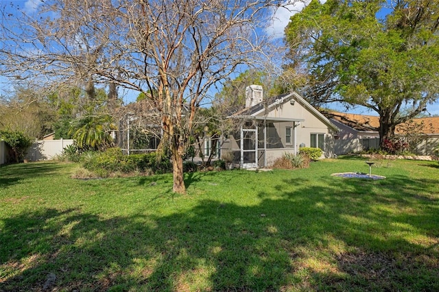 view of yard featuring a fenced backyard and a sunroom