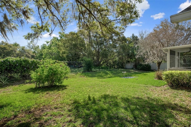 view of yard with a fenced backyard and a sunroom