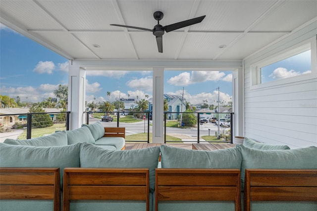 sunroom featuring a ceiling fan