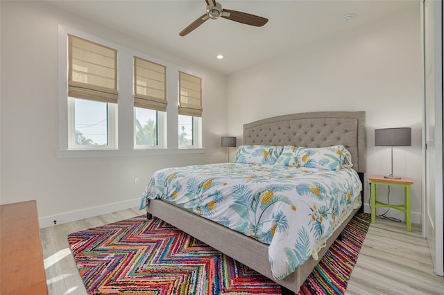 bedroom featuring recessed lighting, baseboards, wood finished floors, and a ceiling fan