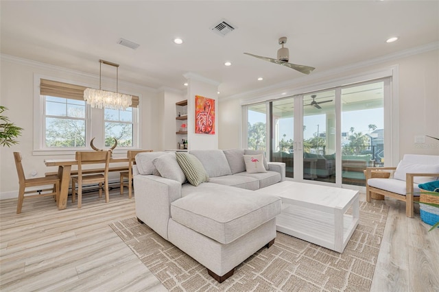 living area with visible vents, recessed lighting, light wood-style floors, and ornamental molding