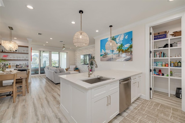 kitchen featuring visible vents, ornamental molding, a sink, stainless steel dishwasher, and white cabinetry