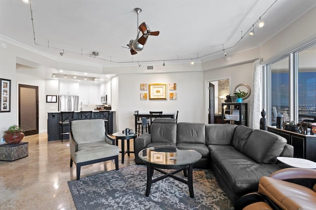 living area with rail lighting, a ceiling fan, visible vents, and ornamental molding