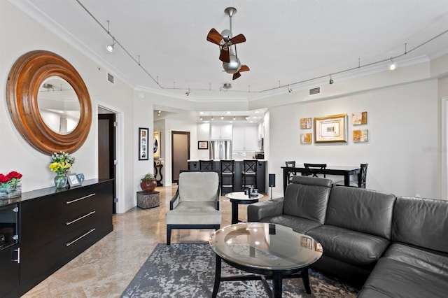 living room featuring visible vents, track lighting, and ornamental molding