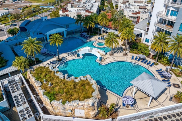 community pool with a community hot tub and a patio