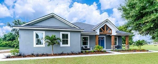 view of front of house featuring a front yard and stucco siding