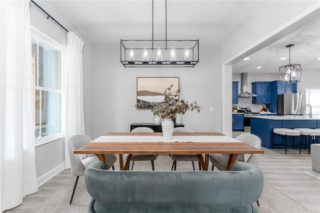 901 Eagle Ln, Apollo Beach, FL 33572 - dining space with a notable chandelier, recessed lighting, baseboards, and light wood-style floors