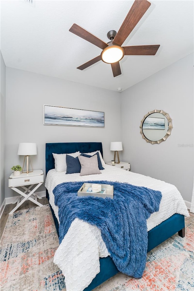 901 Eagle Ln, Apollo Beach, FL 33572 - bedroom featuring baseboards, wood finished floors, and a ceiling fan
