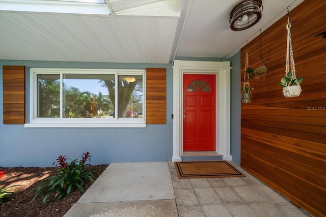 doorway to property featuring stucco siding