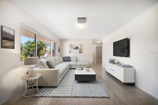 living room featuring visible vents and speckled floor