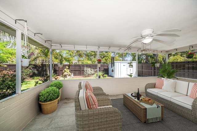 view of patio / terrace with a ceiling fan, a fenced backyard, outdoor lounge area, and an outdoor structure