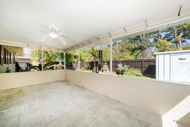 unfurnished sunroom featuring ceiling fan