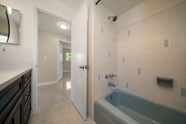 full bathroom with vanity, shower / bathing tub combination, baseboards, and speckled floor